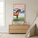 A serene child's room with neutral tones. A light wooden dresser sits against a plain wall, topped with a small white lamp, a stack of books, and a wooden horse pull toy. Above the dresser, a large framed watercolor-style illustration displays a brown horse in a lush green meadow, with layered blue mountains and a soft pink and orange sky behind it. To the right, a cream-colored fabric play tent stands on a textured beige rug. A window is visible on the left.