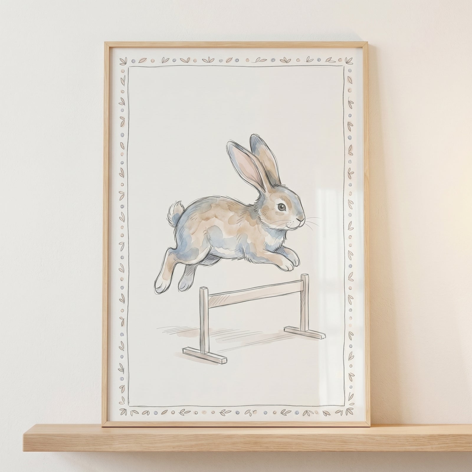 Watercolor hurdle rabbit wall art of a brown rabbit leaping over a small hurdle, displayed in a light wood frame.