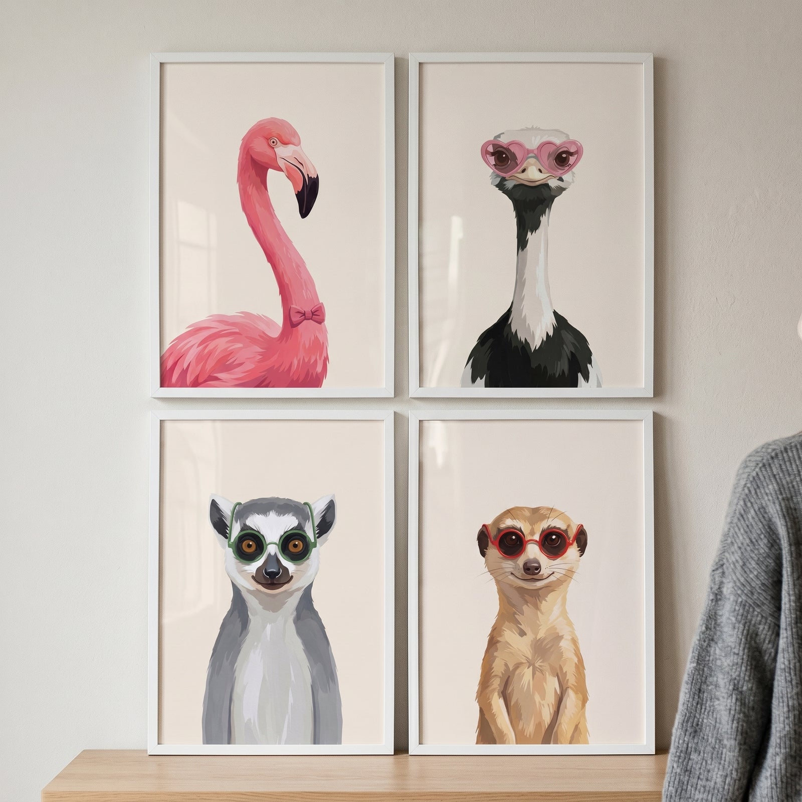 Illustrated accessorized safari animals wall art set of 4 with a flamingo, ostrich, lemur, and meerkat in white frames.
