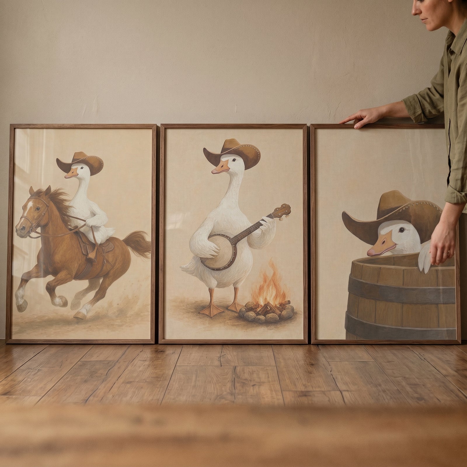 Illustrated rancher white goose wall art set of 3 featuring a goose on a horse, playing a banjo, and inside a barrel.