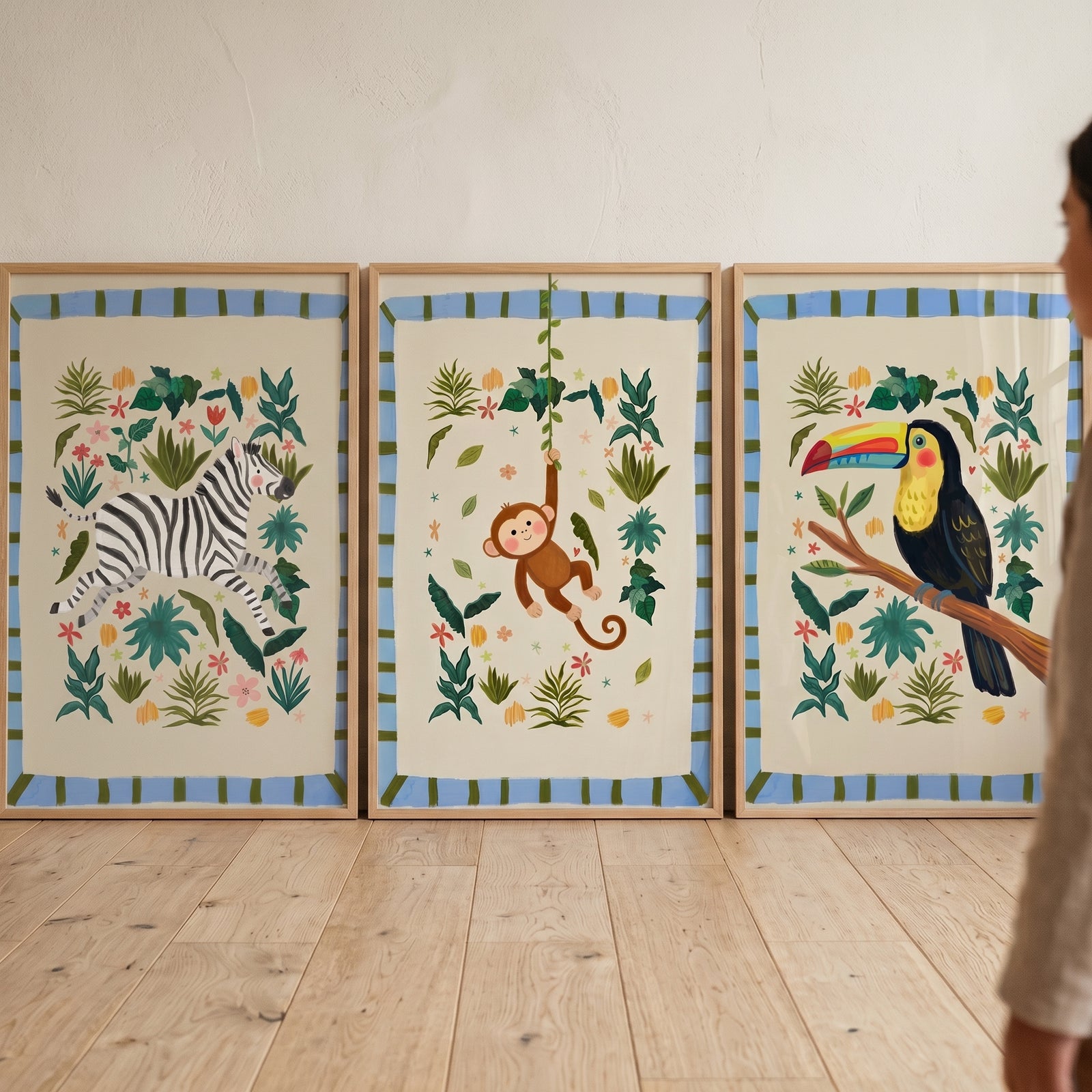 Illustrative botanical jungle animal wall art set of 3 featuring a zebra, monkey, and toucan in light wood frames.