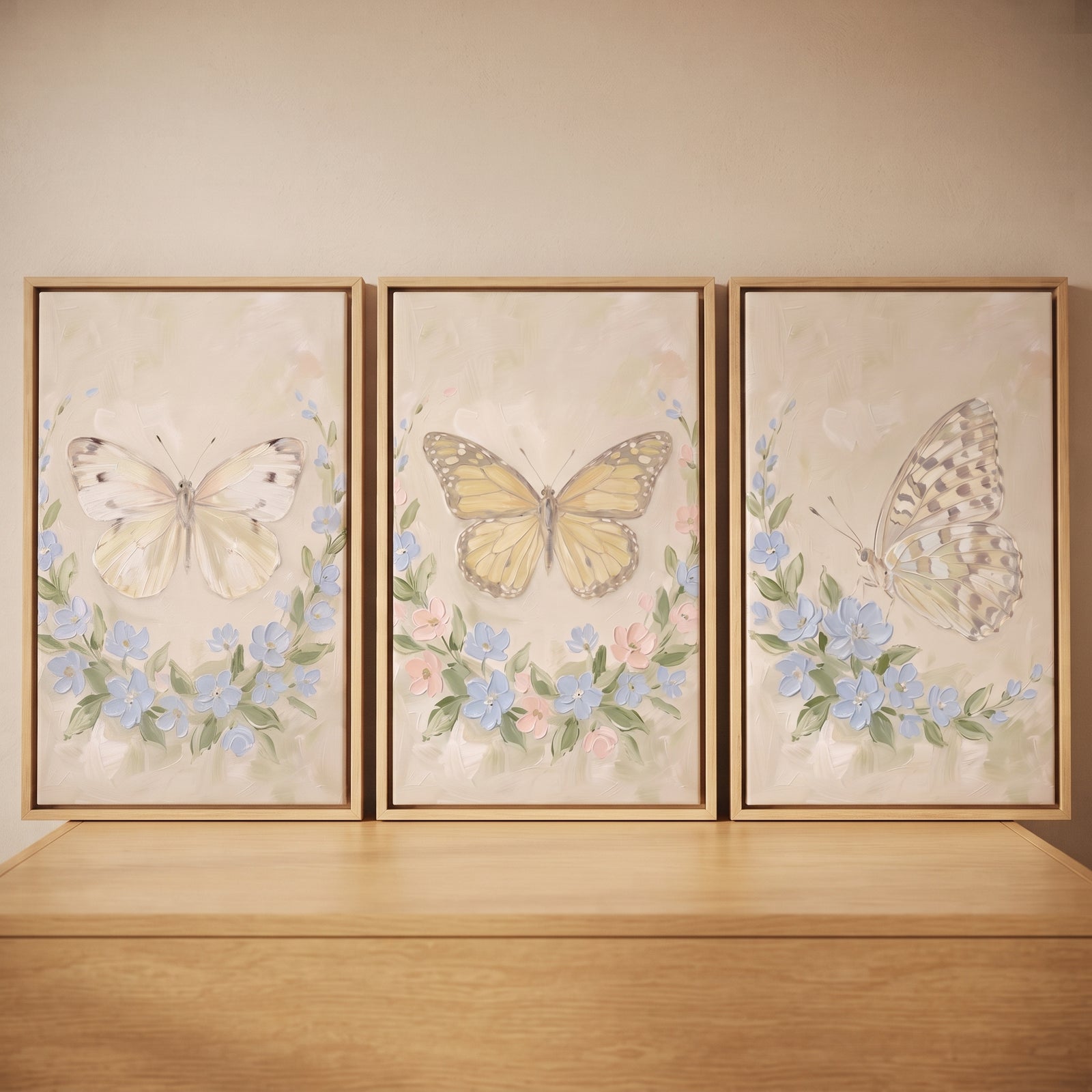 Impasto blue petal butterfly wall art set of 3 featuring cream, yellow, and patterned butterflies over soft floral wreaths.