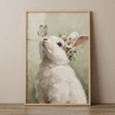 Impasto butterfly white rabbit wall art shows a bunny with a daisy crown looking up at a blue butterfly.