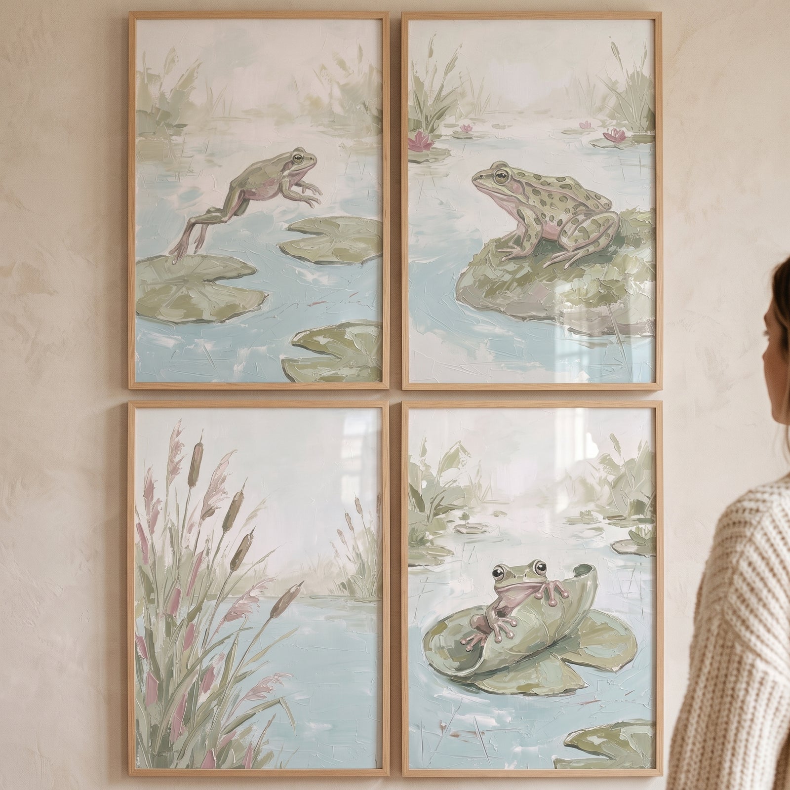 Impasto sage green pond artwork set of 4 featuring frogs and lily pads on a wall next to a person in a sweater.