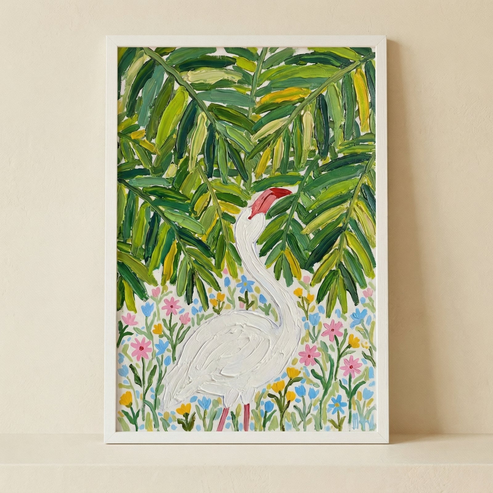 Framed painting of a white bird standing among colorful wildflowers beneath large green tropical leaves. The textured brushstrokes and bright foliage create a lively nature inspired focal point against a neutral wall.