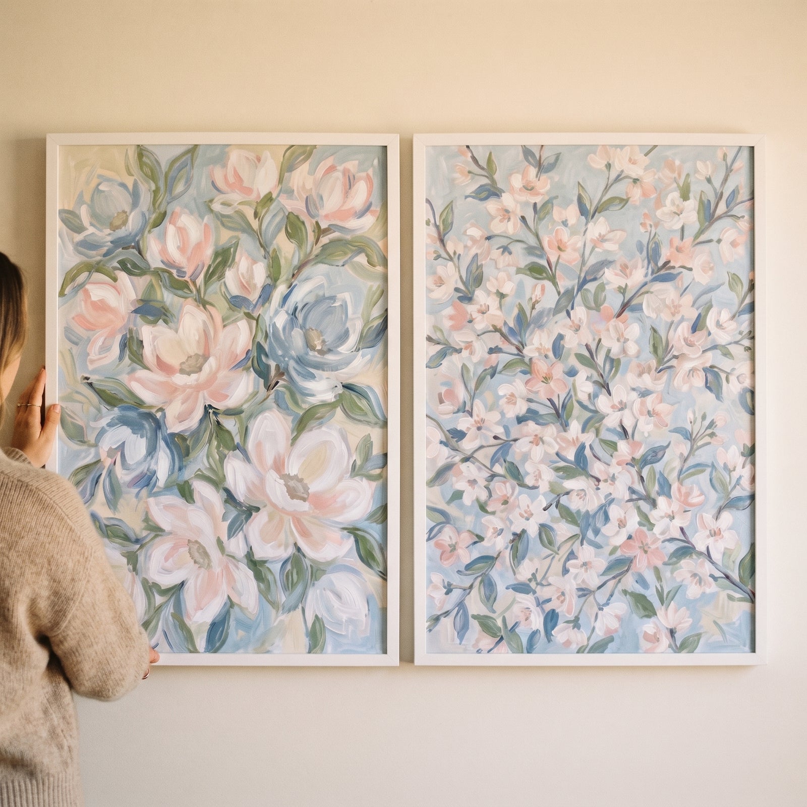 Impressionist airy garden botanical floral artwork set of 2 with soft pink and blue blossoms held against a white wall.