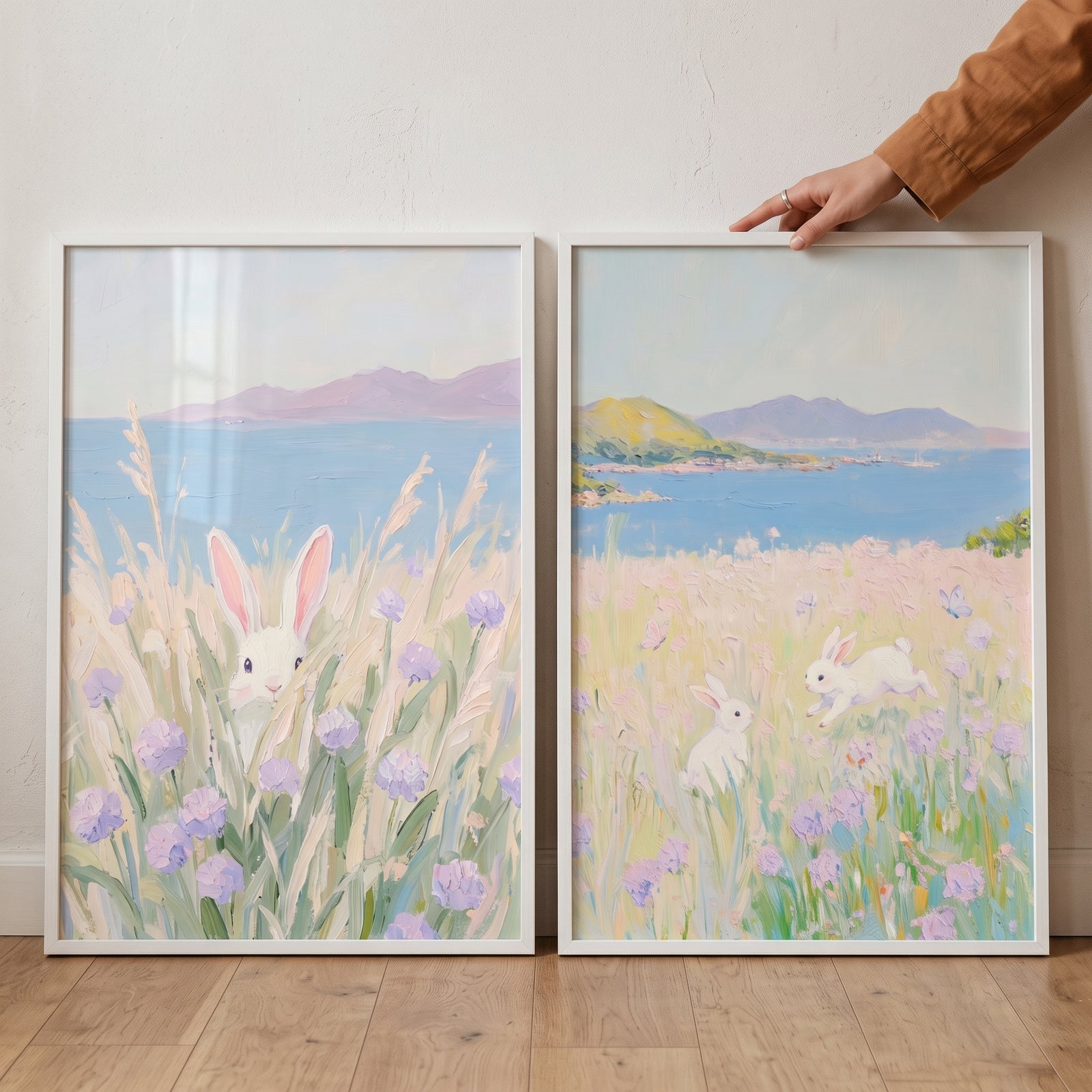 Impressionist coastal lavender bunny wall art set of 2 with white rabbits in fields of purple flowers by the ocean.