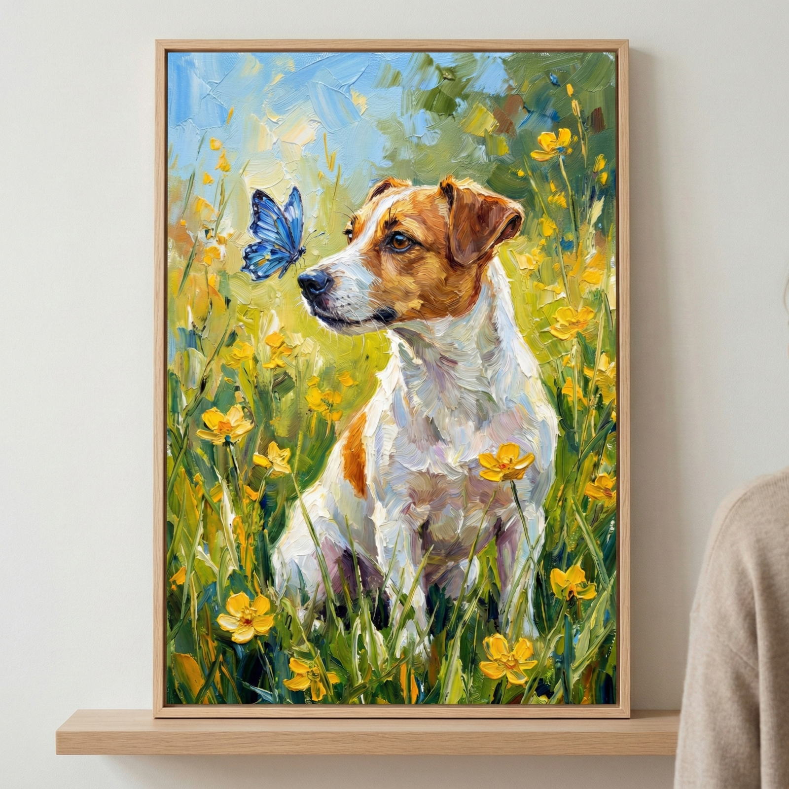 An impressionistic style artwork featuring a small brown and white dog sitting amidst a field of tall green grass and bright yellow flowers. The dog is captured in profile, gaze fixed on a vibrant blue butterfly hovering just before its nose. The scene is rendered with thick, energetic brushstrokes that give it a rich texture. The sky above is a bright, sun-dappled blue. The framed piece sits on a light wooden shelf against a plain background.