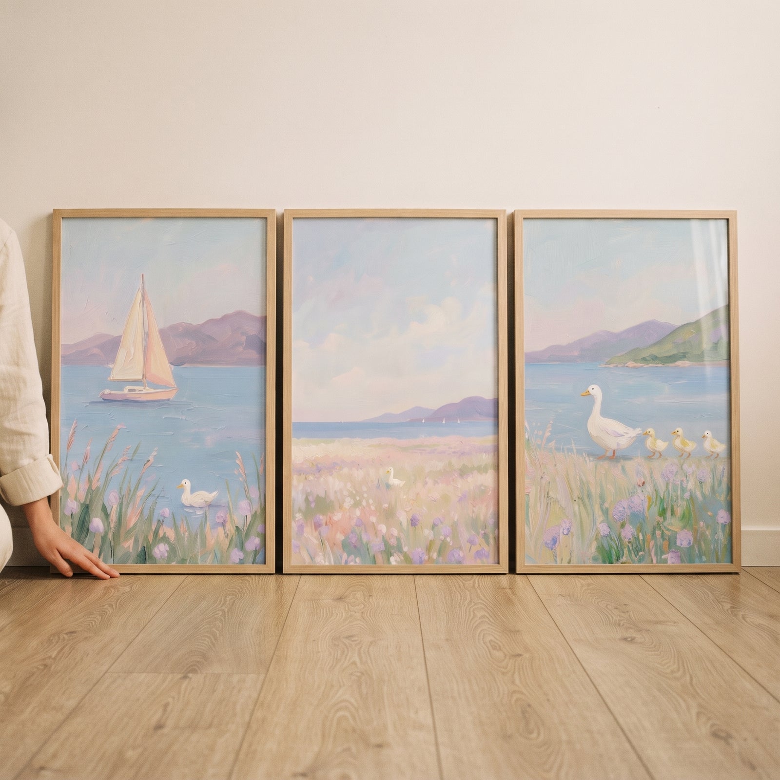 Impressionist lavender coastal duck wall art set of 3 shows a sailboat and ducks among flowers by the sea.