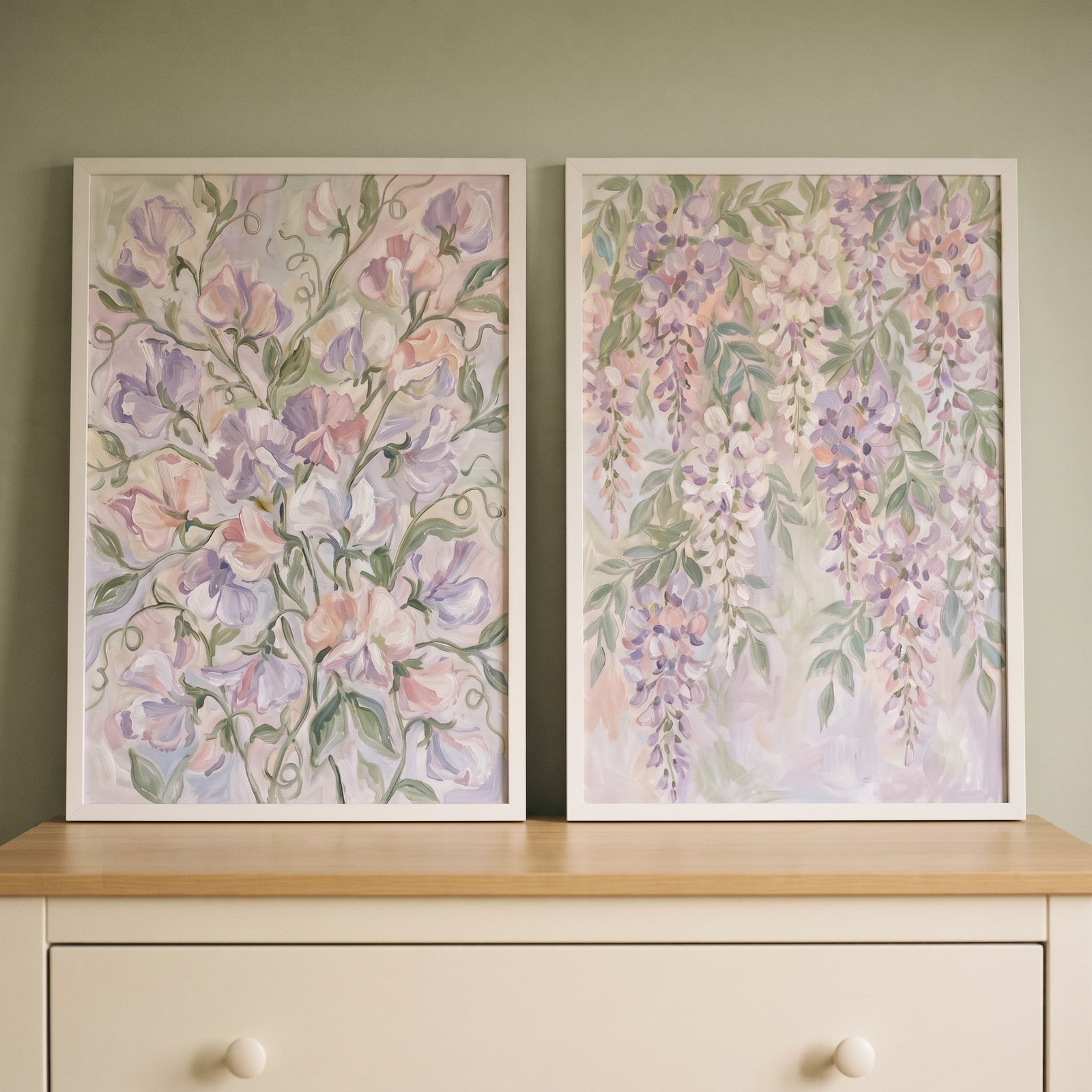 Impressionist lilac botanical floral artwork set of 2 in white frames on a dresser against a sage green wall.