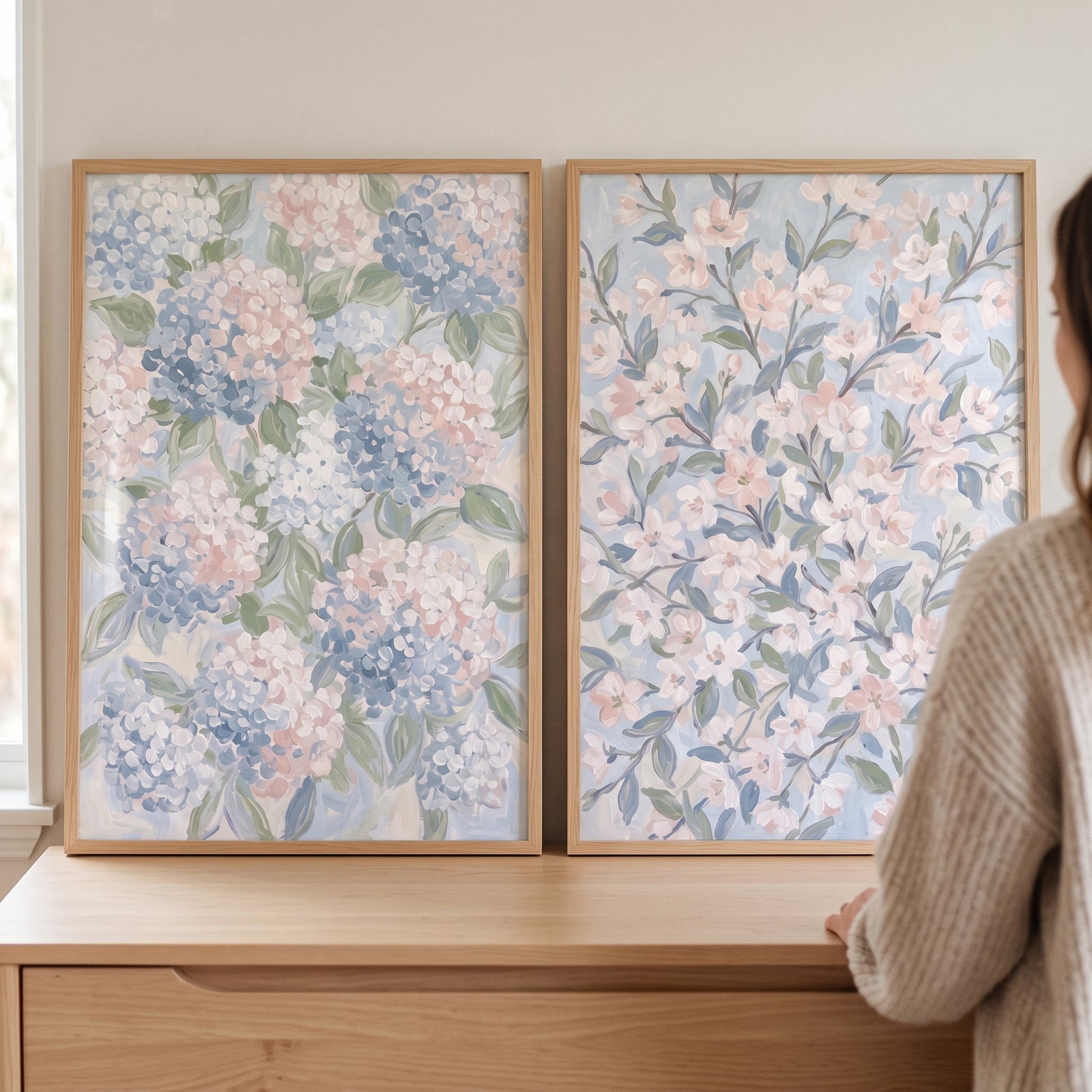 Impressionist pastel garden floral wall art set of 2 featuring hydrangeas and blossoms in light wood frames on a dresser.
