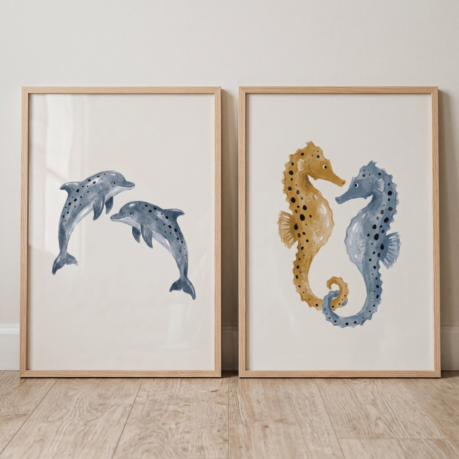 Indigo ochre marine animal wall art set of 2 featuring blue dolphins and seahorses in light wood frames.
