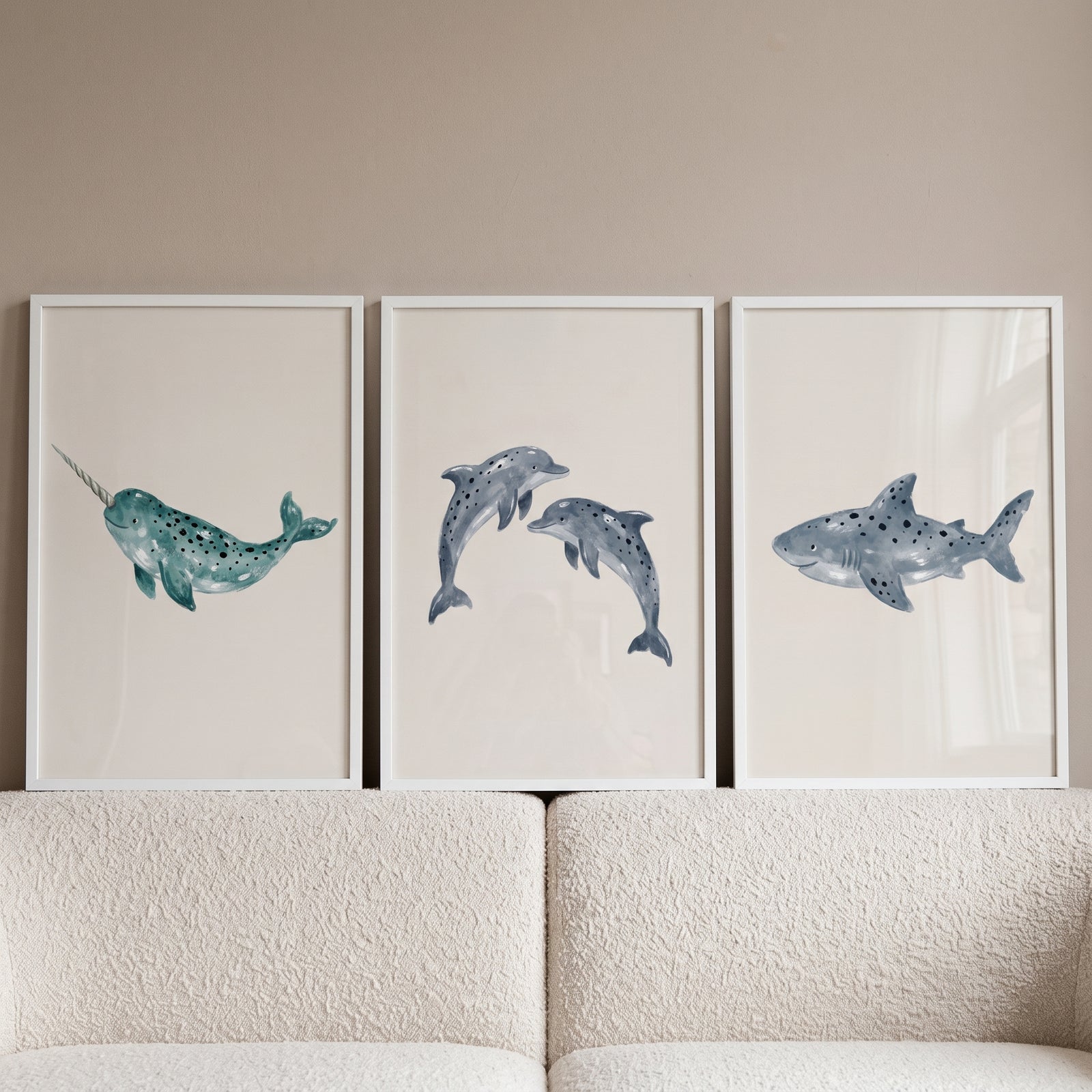 Indigo speckled sea animal wall art set of 3 featuring a narwhal, dolphins, and a whale shark in white frames.