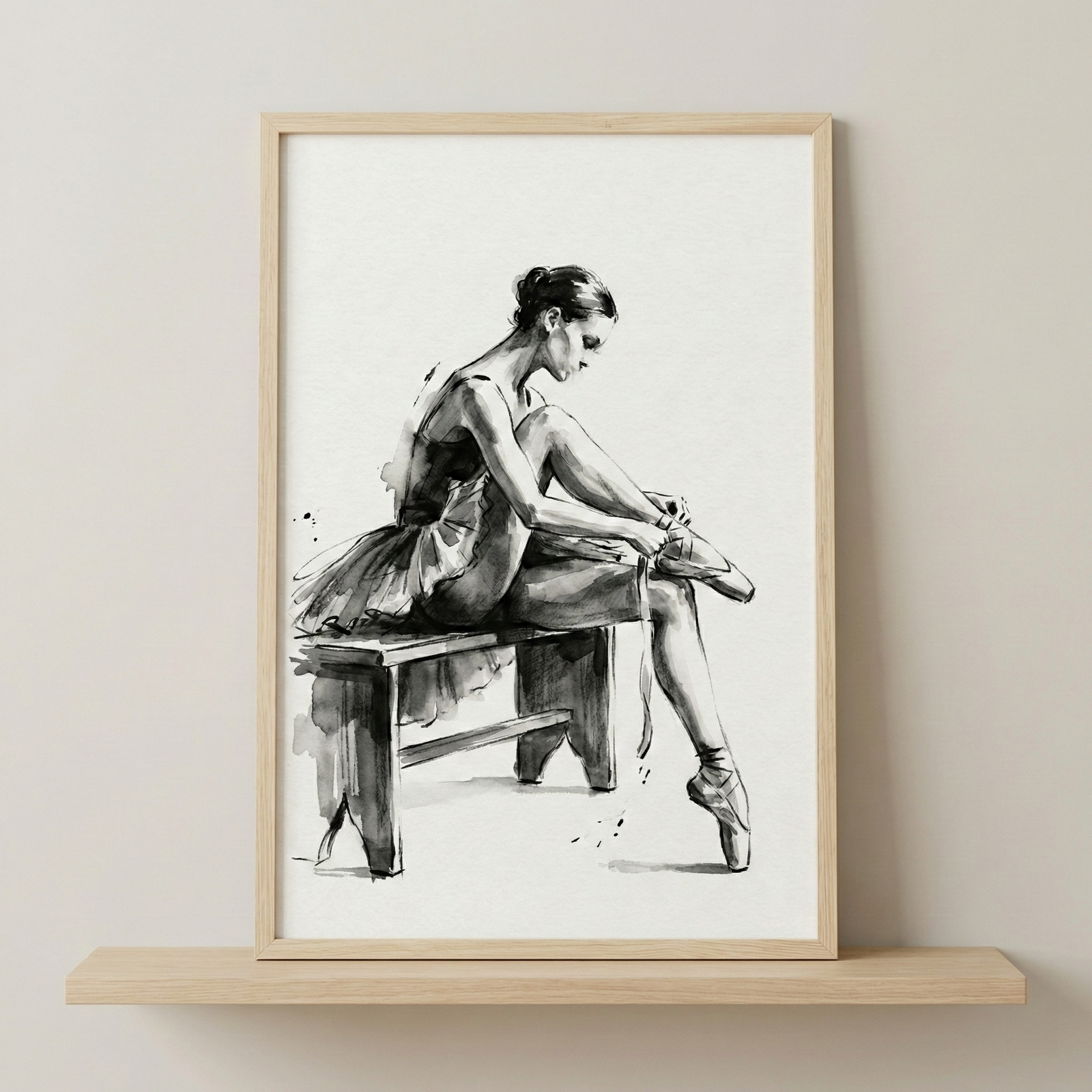 A monochromatic illustration of a ballet dancer seated on a simple wooden bench. The figure is captured in profile, leaning forward to tie the ribbon of her pointe shoe on a raised leg. Her other foot rests delicately on its toe. The artwork uses expressive black ink or watercolor-style strokes against a white background, creating a minimalist and graceful aesthetic. It is showcased in a light-toned wooden frame resting on a shelf.