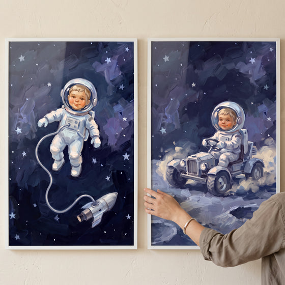 Inky blue baby astronaut wall art set of 2 depicts a baby floating in deep space and driving a rover on the moon.