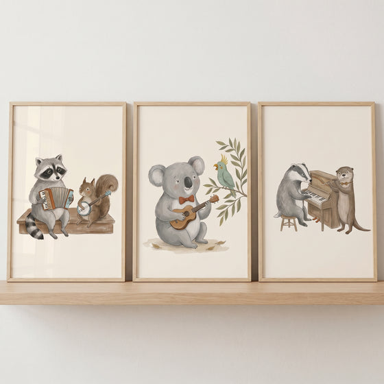 Instrument playing woodland animals wall art set of 3 with a raccoon, squirrel, koala, bird, badger, and otter on a shelf.