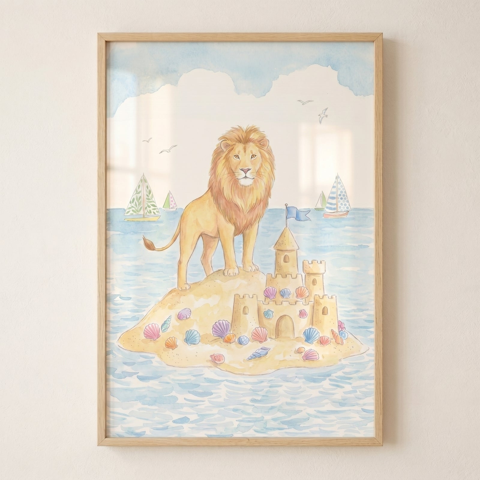 Island sandcastle beach lion wall art with a watercolor lion, sandcastle, and sailboats in a light wood frame.