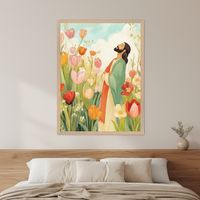 Modern bedroom with a wooden headboard and bed with pillows. A framed painting of a bearded man in a green and red robe in a field of colorful tulips, looking up at a blue sky, hangs above the bed. A small potted plant is on a nightstand to the right.