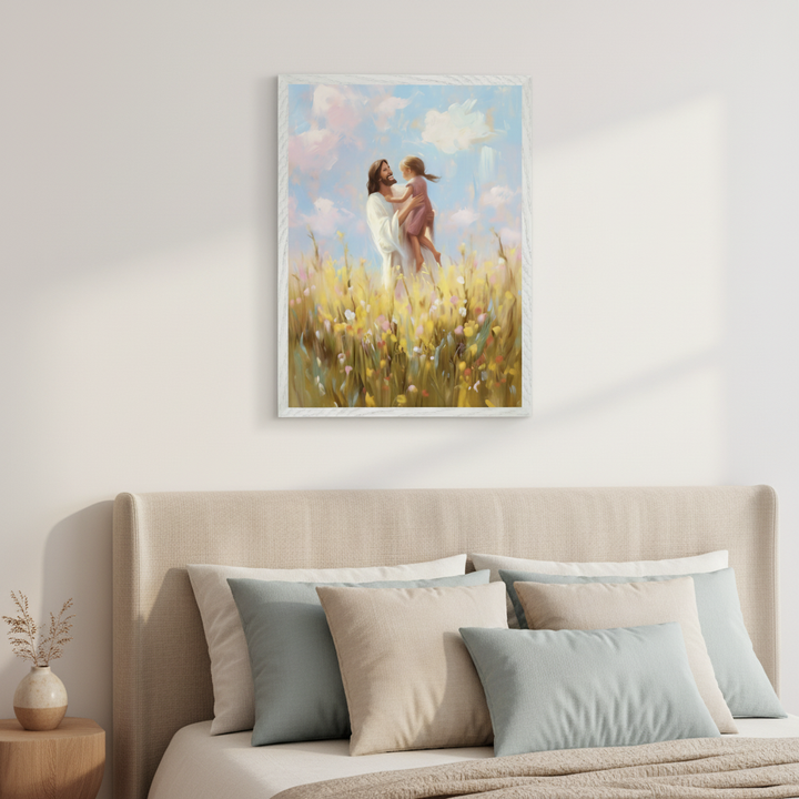 Modern bedroom with a bed featuring a beige headboard. A framed, painterly artwork depicting Jesus holding a child in a field of wildflowers under a cloudy sky hangs centered above the bed.