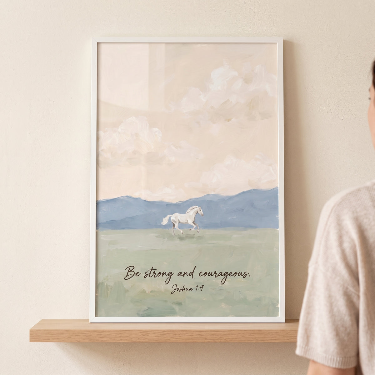 Joshua scripture white horse wall art shows a horse in a field with mountains and text be strong and courageous Joshua 1:9.