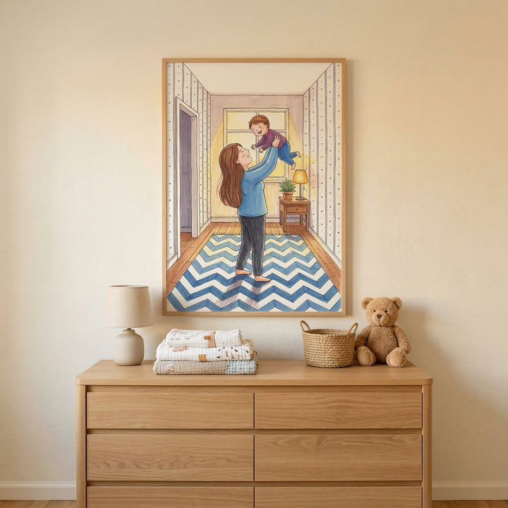 A framed illustration hangs on a neutral-toned wall, positioned above a light-colored wooden dresser. The artwork within the frame depicts a tender moment between a mother and her baby in a hallway. The woman, with long brown hair, is wearing a blue long-sleeved shirt and dark pants. She is joyfully lifting a smiling infant, who is dressed in a purple top and blue bottoms. 