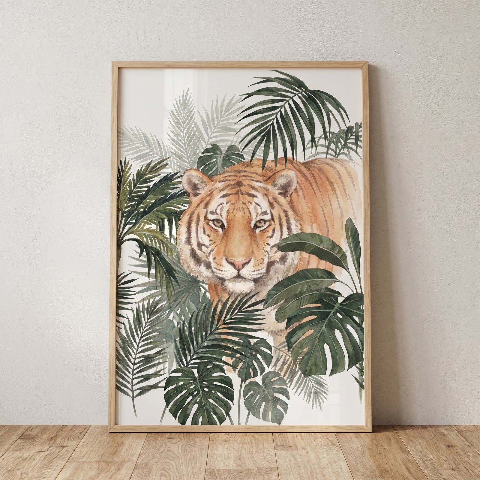 Framed jungle leaf tiger wall art shows a tiger peering through green tropical palm fronds and monstera leaves.
