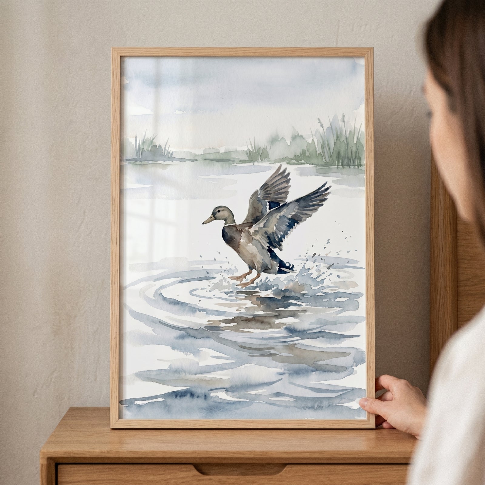 Framed landing mallard duck wall art in watercolor style, showing a duck with wings spread as it splashes onto water.