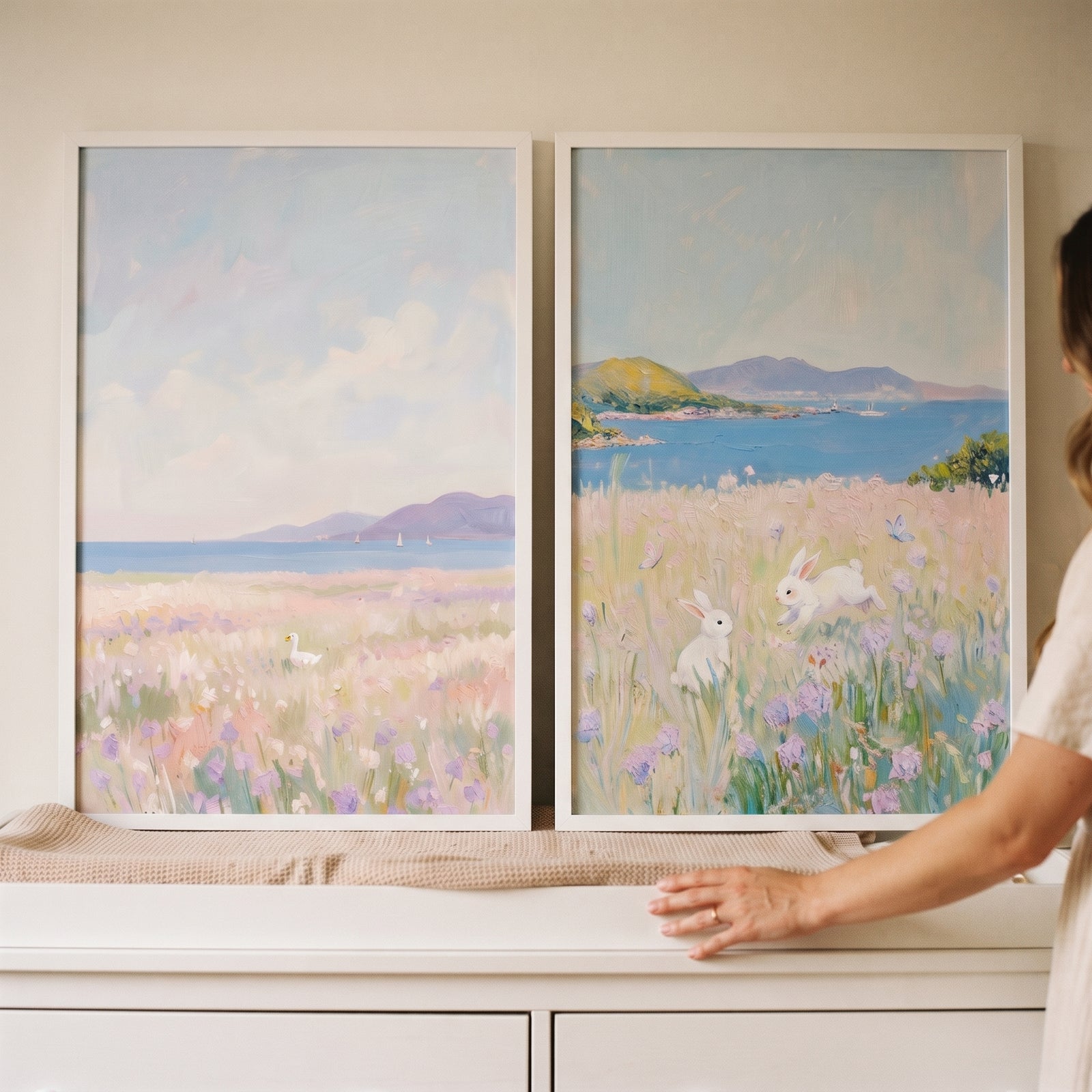 Lavender coastal white animals wall art set of 2 shows rabbits and a bird in soft pastel seaside flower fields.