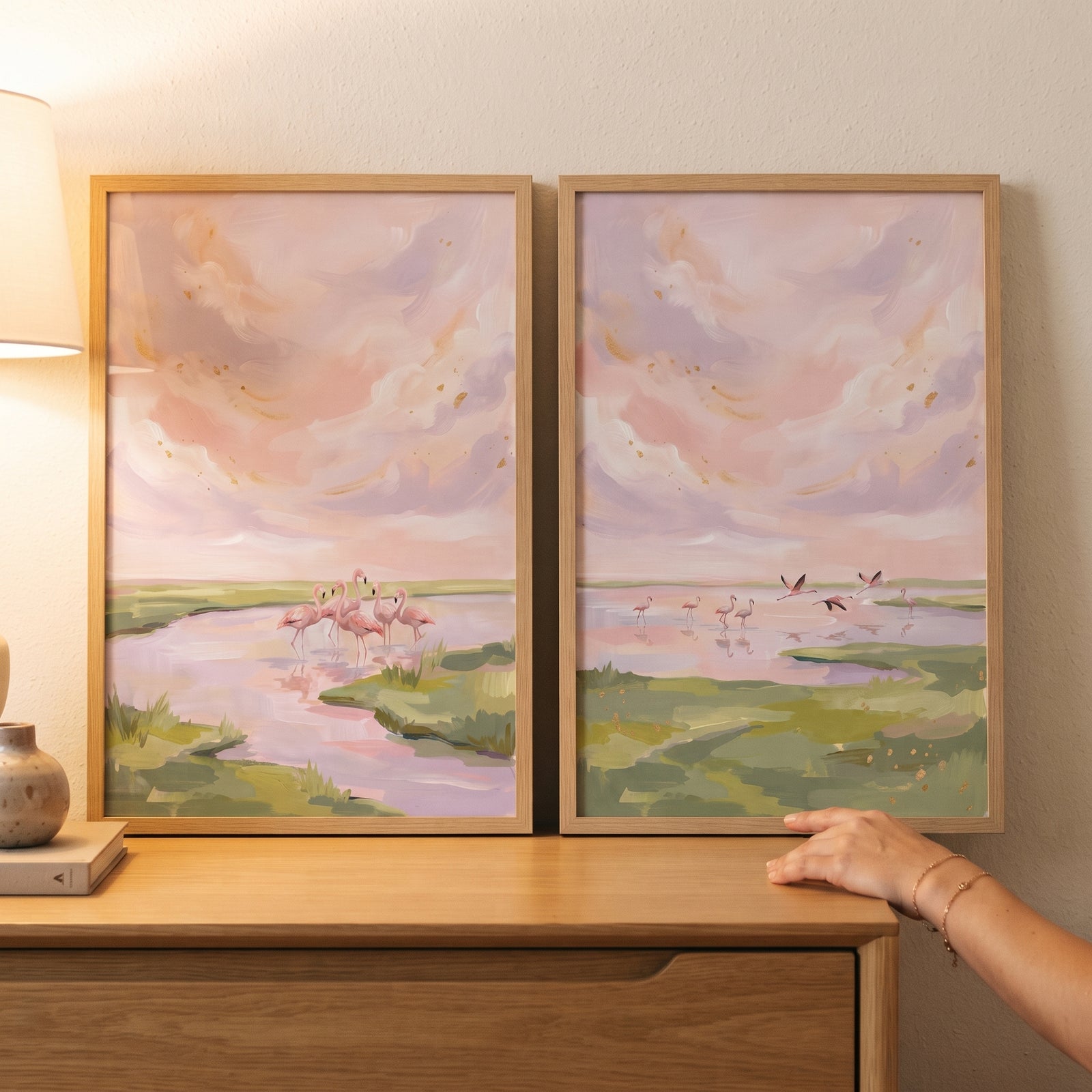 lavender gold sky flamingo wall art set of 2 on a wooden dresser, showing pink birds wading in a soft pastel landscape.