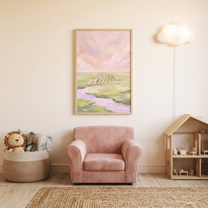Lavender sky walking giraffe animal wall art hangs above a pink velvet chair in a nursery with a cloud lamp and toys.