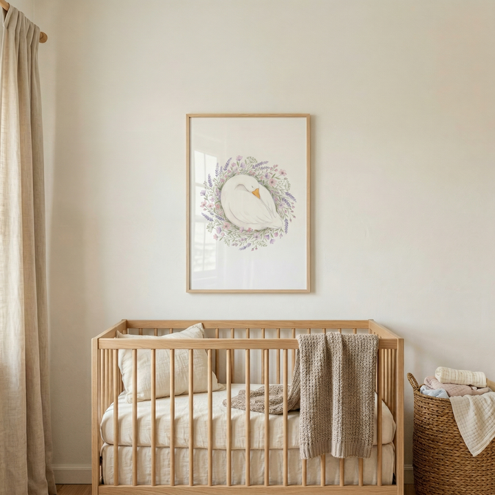A vertical indoor shot features a nursery with a wooden crib against a neutral-toned wall. Above the crib, a light wood-framed artwork depicts a white goose curled in a nest made of pastel-colored flowers. The light wood crib features a mattress with off-white and beige vertical-striped bedding and a matching pillow on the left side. 