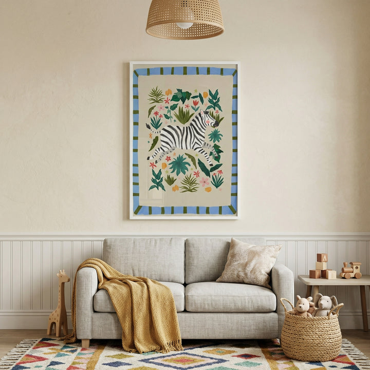 Cozy nursery corner with a neutral sofa and woven basket of plush toys, styled beneath framed zebra wall art with colorful botanical accents. The print adds playful safari nursery decor while complementing soft textures like a knit throw and patterned rug.