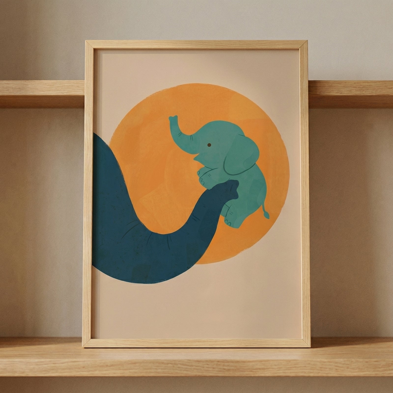 Minimalist framed illustration of a baby elephant being lifted by an adult elephant trunk in front of a warm orange circle, resting on a wooden shelf. The soft colors and playful design make it a gentle focal point for a nursery or child’s room.