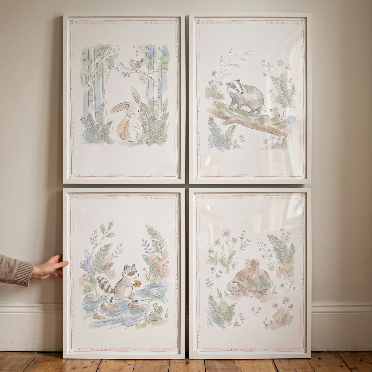 Light pastel woodland animal wall art set of 4 featuring a bunny, badger, raccoon, and turtle in a watercolor style.