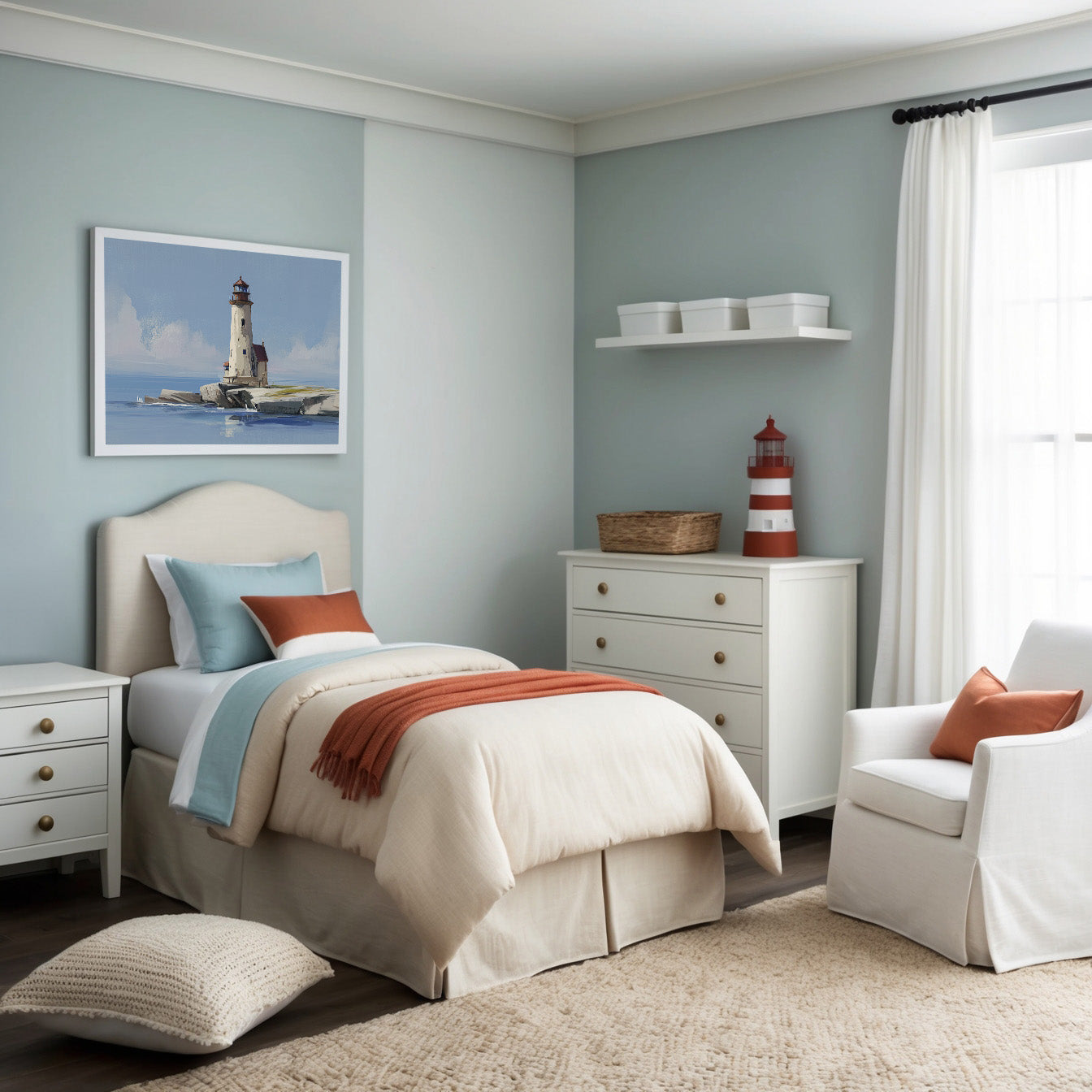 Serene coastal-themed bedroom with muted blue walls and cream-colored furnishings accented by soft coral tones. A framed artwork above the bed depicts a tranquil lighthouse standing on a rocky shoreline, enhancing the room's relaxing nautical aesthetic.