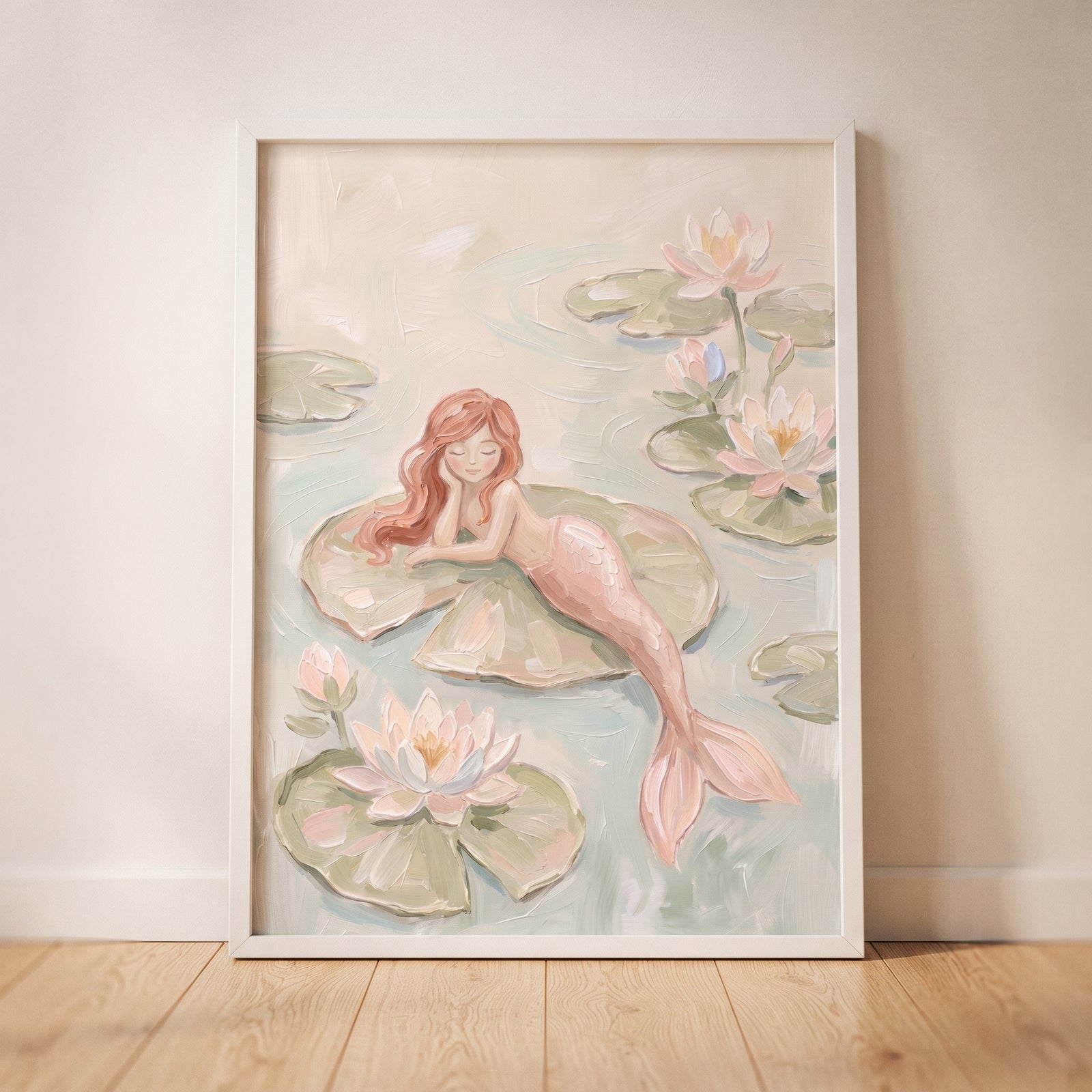 Lily pad pink mermaid wall art of a red-haired mermaid resting on a large leaf among soft pink water lilies.