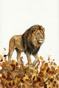 Close-up of a watercolor illustration featuring a lion with a full mane, standing on a bed of golden and brown splashes that evoke natural terrain. The detailed animal artwork is framed in wood and propped on a neutral fabric surface.
