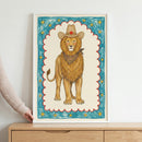 A whimsical, child-like illustration of a majestic lion wearing a brown cowboy hat with a red star and a leopard-print bandana, centered within a scalloped red border on a textured blue background filled with yellow stars.
