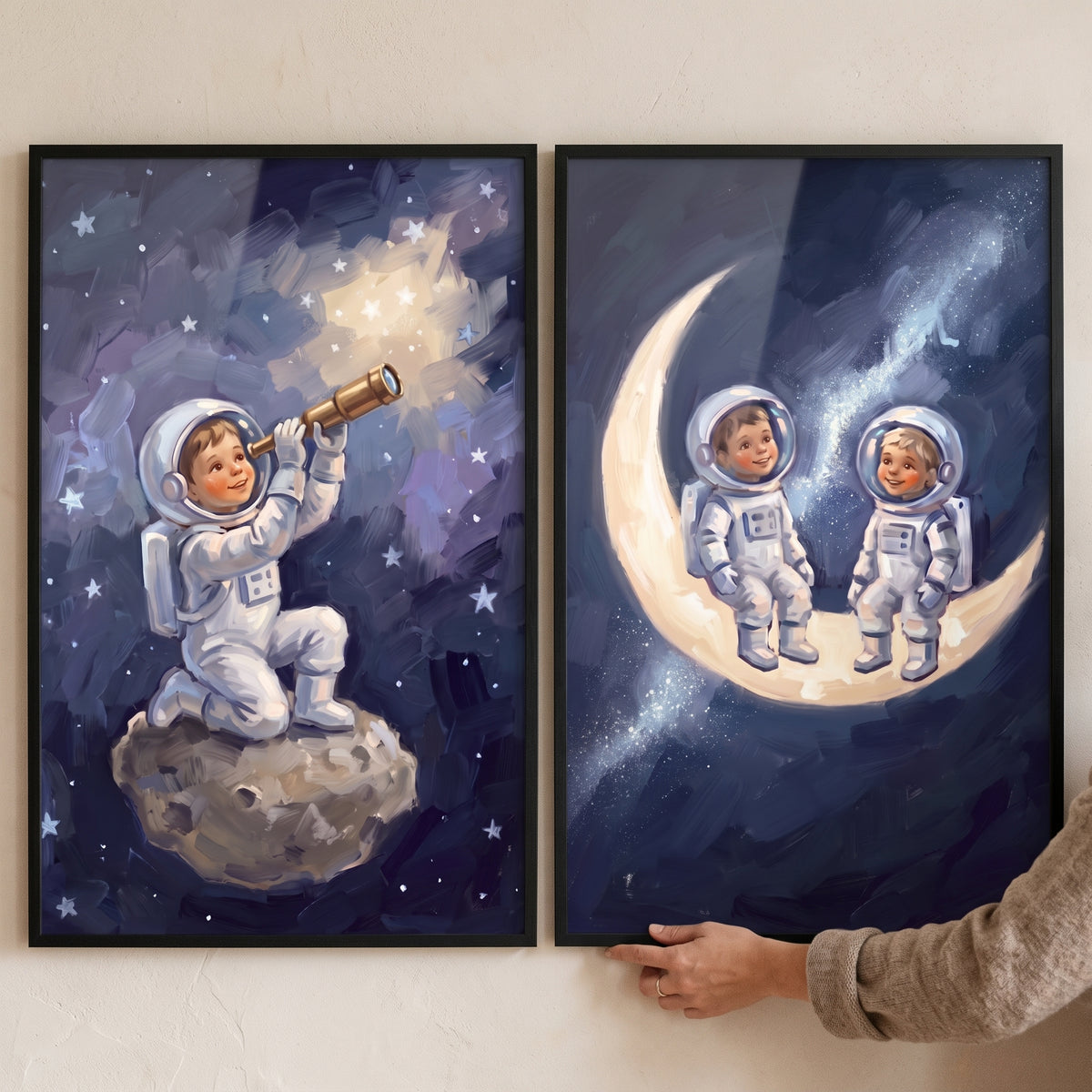 Little explorer baby astronaut wall art set of 2 with kids in space suits on a crescent moon and using a telescope.
