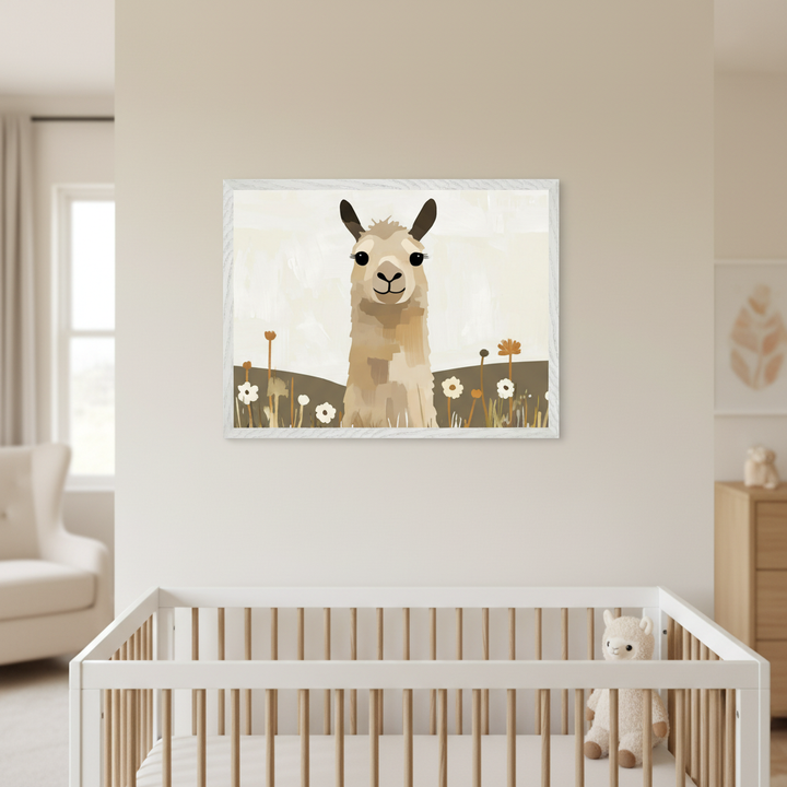 Modern nursery with a white and natural wood crib. A framed illustration of a light brown llama in a field with white and brown flowers hangs centered on the wall above the crib. A cream armchair is left, a wooden dresser right.