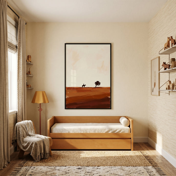 Warm room with a wooden daybed, floor lamp, and lone windswept desert tree wall art above a textured jute rug.