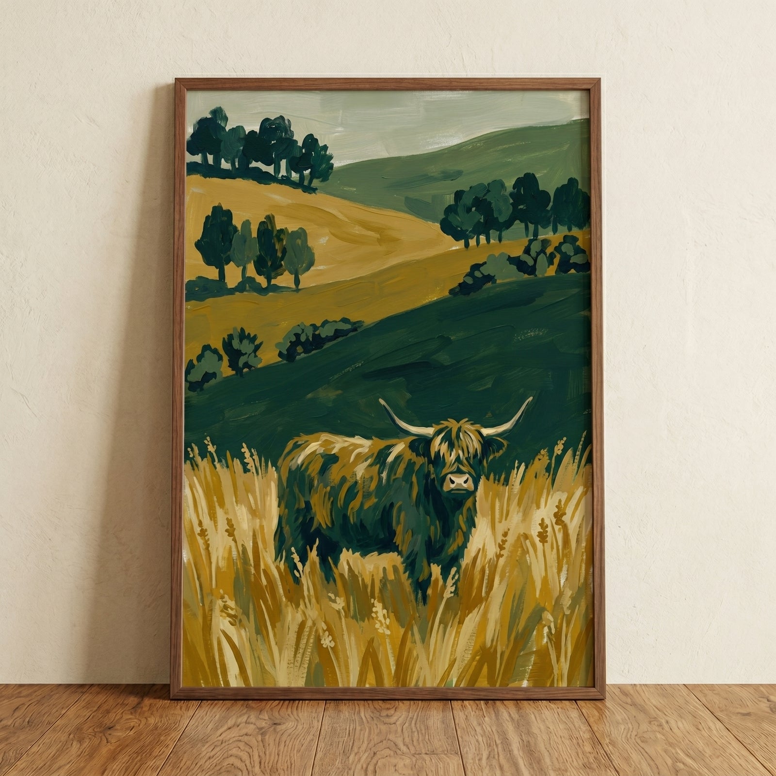 Long horned highland cow wall art in a frame featuring a shaggy cow standing in yellow grass among rolling green hills.