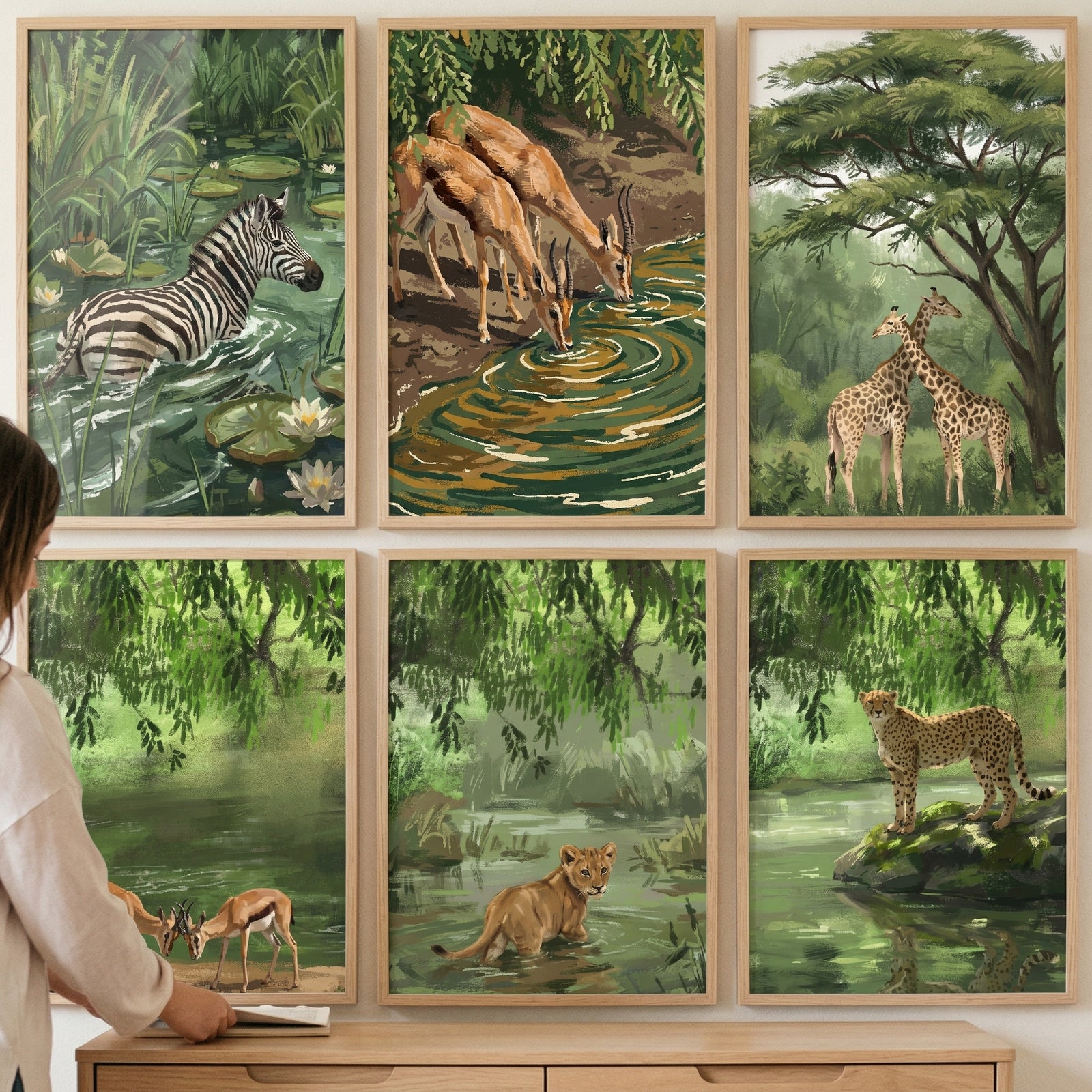 Six framed animal prints of a zebra, giraffes, and big cats form this lush green safari animal wall art set of 6.