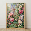 A framed vertical artwork depicts an enchanting scene with two fairies amidst a lush garden of roses. The upper fairy, with delicate iridescent blue and purple wings, balances on a thorny rose branch and pours a stream of milk from a small floral-patterned pitcher. 