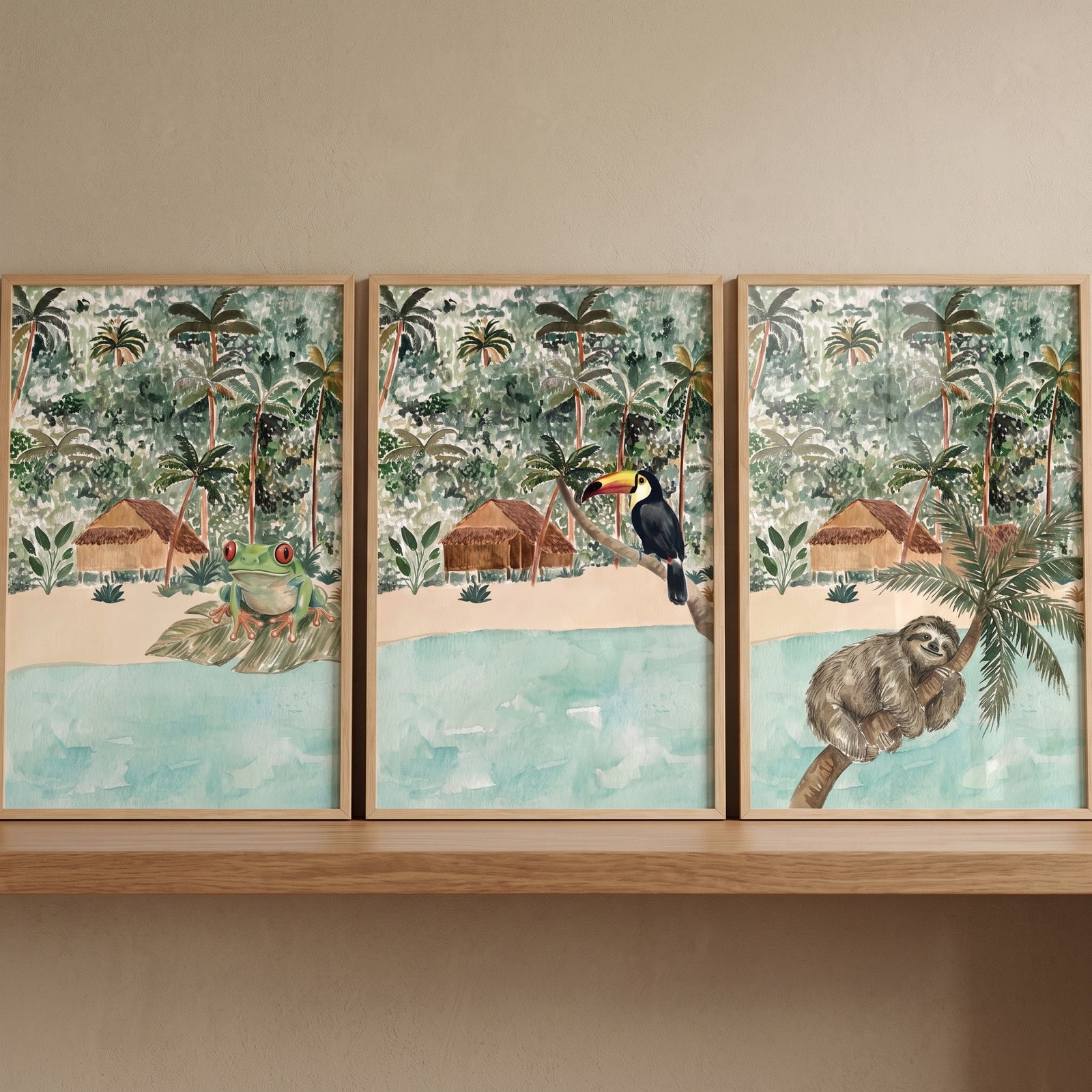 Lush watercolor jungle animals wall art set of 3 featuring a frog, toucan, and sloth on a wooden shelf.