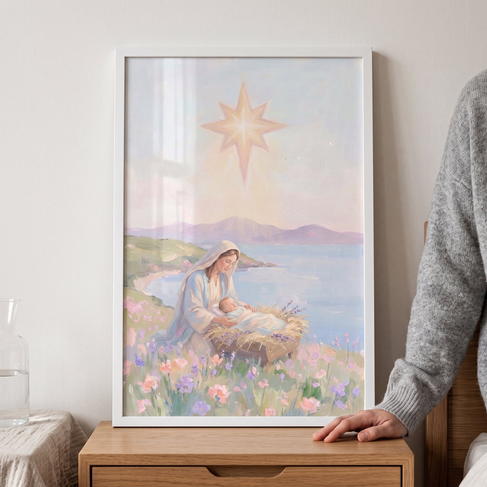 Framed manger scene baby jesus wall art of Mary and her child in a flower field by a lake under a bright glowing star.