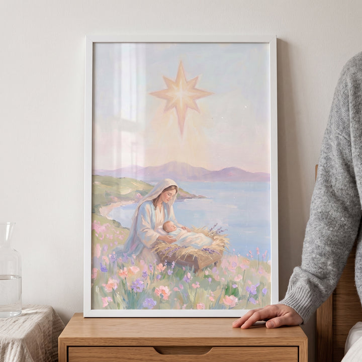 Framed manger scene baby jesus wall art of Mary and her child in a flower field by a lake under a bright glowing star.