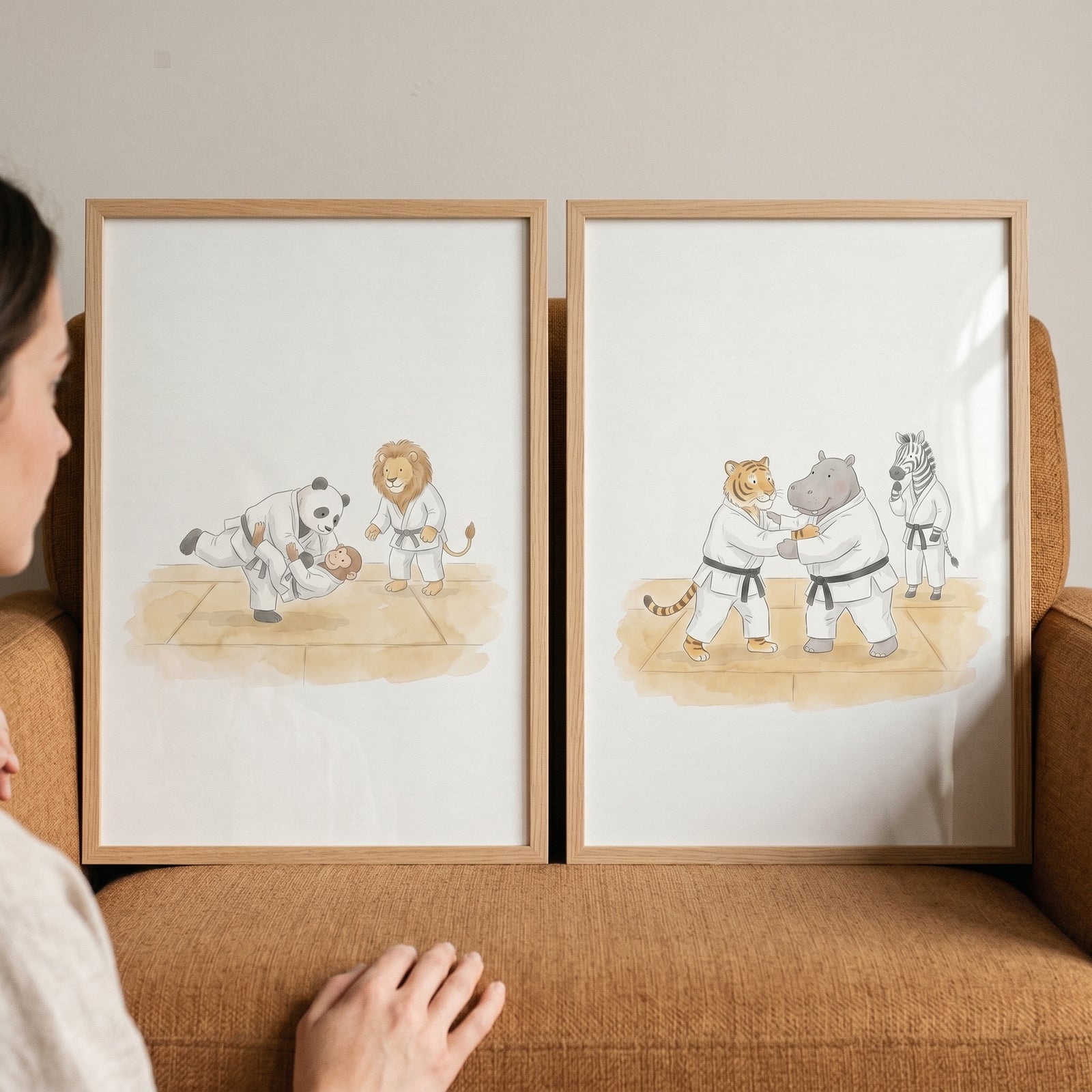 Martial arts safari animals wall art set of 2 features framed illustrations of animals in judo uniforms on a chair.