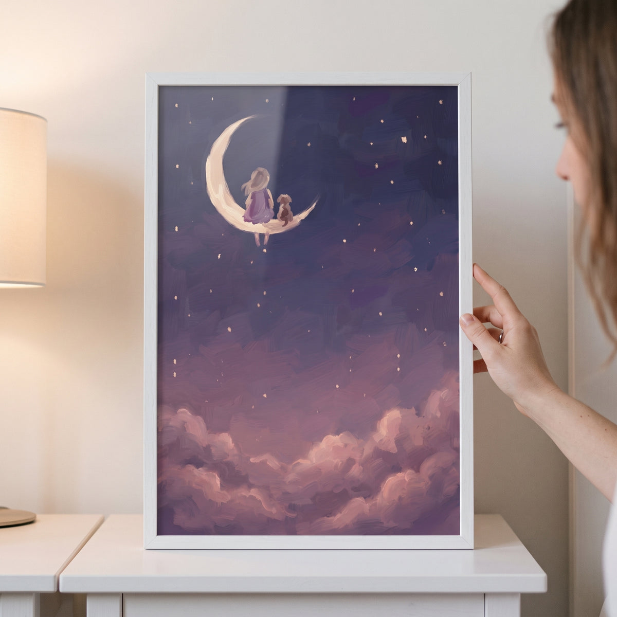 Framed mauve cloud girl dog wall art depicts a child and dog on a crescent moon above soft clouds and a starry sky.