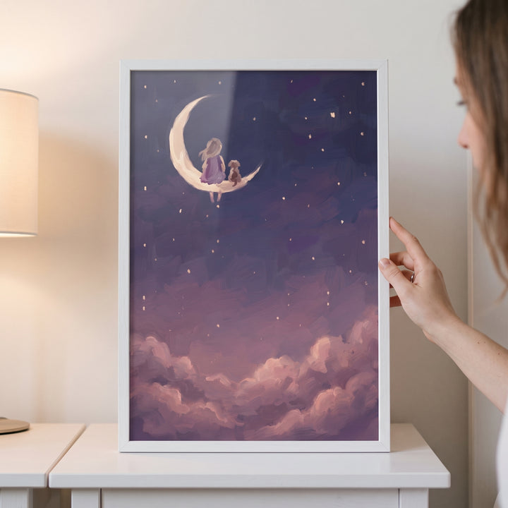 Framed mauve cloud girl dog wall art depicts a child and dog on a crescent moon above soft clouds and a starry sky.